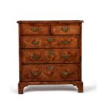 A Queen Anne walnut, burr walnut and feather banded bachelor's chest of drawers