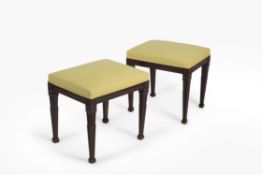 A pair of George III mahogany and upholstered stools