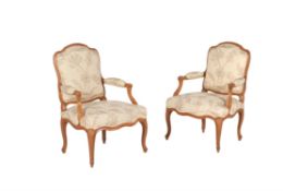 A pair of Louis XV beech and upholstered fauteuil