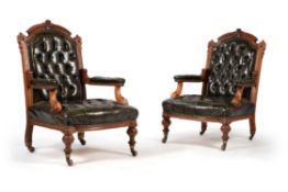 A pair of Victorian walnut and leather upholstered library arm chairs