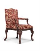 A George II carved 'red walnut' Gainsborough armchair, circa 1755, in the manner of Wright & Elwick