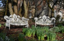 A pair of English white painted cast iron 'oak and ivy pattern' garden benches