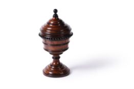 A turned yew and ebonised urn and cover, English or Dutch, 19th century