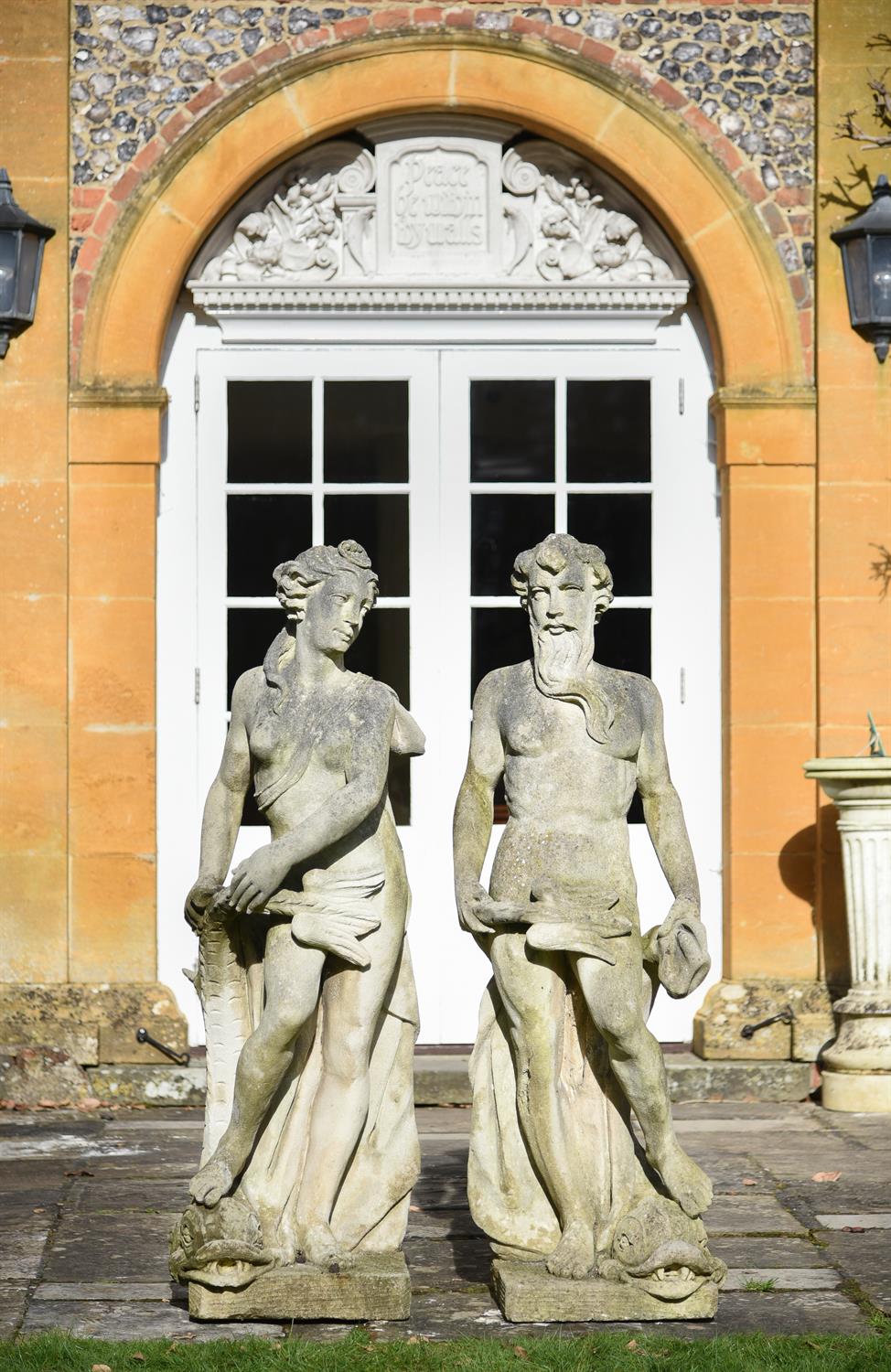 A pair of carved stone garden models of Neptune and Amphitrite in Neoclassical style