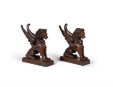 A pair of North European carved oak models of winged lions