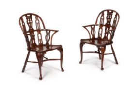 A pair of yew and mahogany Gothic Windsor armchairs