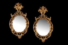 A pair of giltwood oval wall mirrors, in 18th century style, mid 19th century