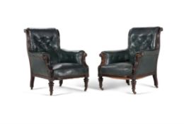 A pair of Victorian ebonised and leather upholstered armchairs