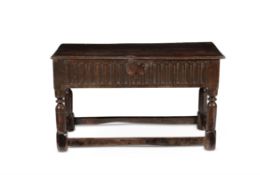 An unusual Charles I oak counter table or chest table