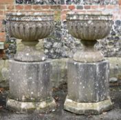 A pair of English garden urns on plinths in Gothic Revival style