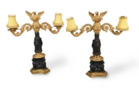 A pair of patinated and parcel gilt bronze twin branch candelabra, mid-19th century