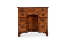 A George II walnut and crossbanded kneehole desk