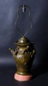 An Art Nouveau patinated bronze vase table lamp, to a design by Louis Coustaury (French, ?-1897)