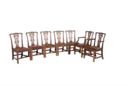 A set of fourteen mahogany dining chairs