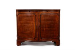 A George III mahogany serpentine fronted commode or side cabinet