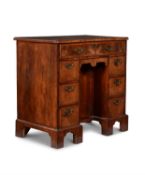 A George I walnut and feather banded kneehole desk