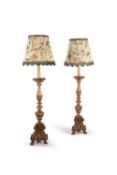 A companion pair of Italian giltwood altar sticks adapted as standard lamps