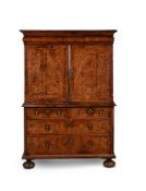 A Queen Anne walnut and feather banded cabinet on chest, circa 1710