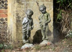 A pair of lead garden models of putti