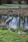 A pair of Japanese patinated metal models of storks