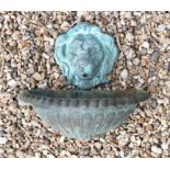 A verdigris bronze lion mask wall fount