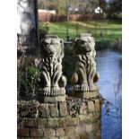 A pair of stone composition heraldic finials modelled as lions sejant