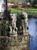 A pair of stone composition heraldic finials modelled as lions sejant