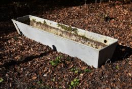 A white painted iron trough