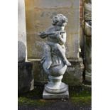A stone composition model of a standing putto holding a cornucopia