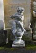A stone composition model of a standing putto holding a cornucopia