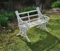 A Victorian cream painted cast iron garden bench