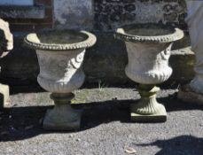 A pair of small-scale stone composition garden vases