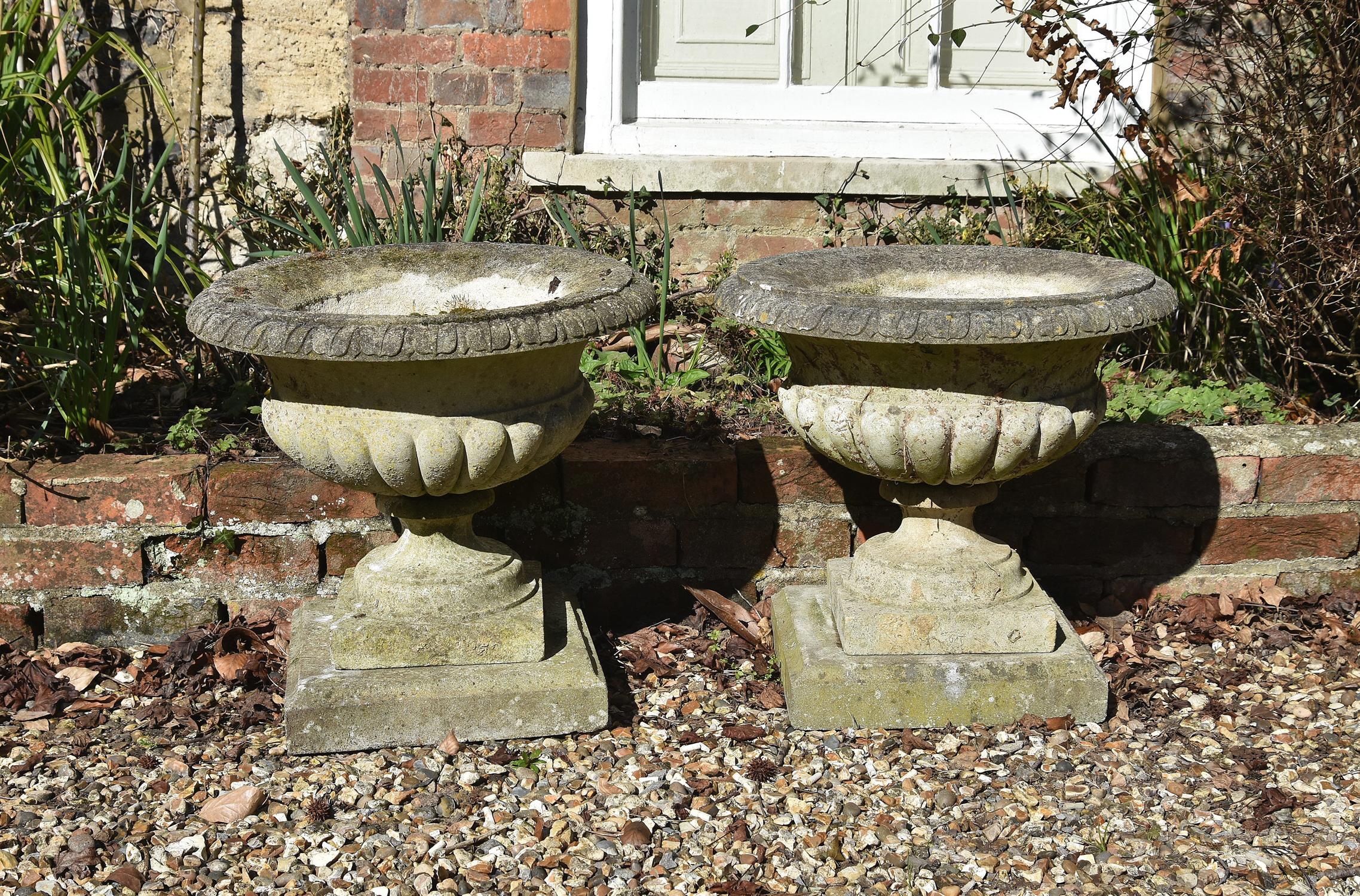 A pair of small stone composition planters