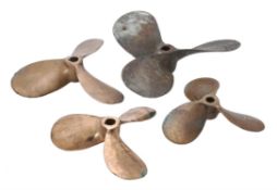 A collection of four bronze boat propellers