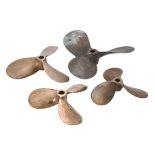 A collection of four bronze boat propellers