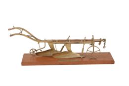 A brass model of a horse drawn two furrow agricultural plough