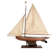 A fine period sailing pond yacht.Length is 122 cm. Height with base is 125cm.