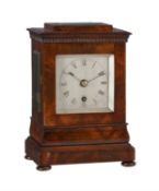 A Victorian figured mahogany small four-glass library mantel timepiece