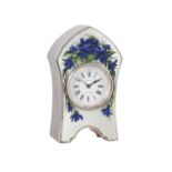 An Edwardian polychrome floral enamelled engine-turned silver small boudoir timepiece