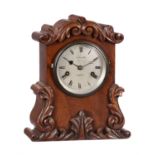 A Victorian carved mahogany small mantel clock