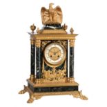 A French ormolu and verde antico marble mantel clock in the Empire taste