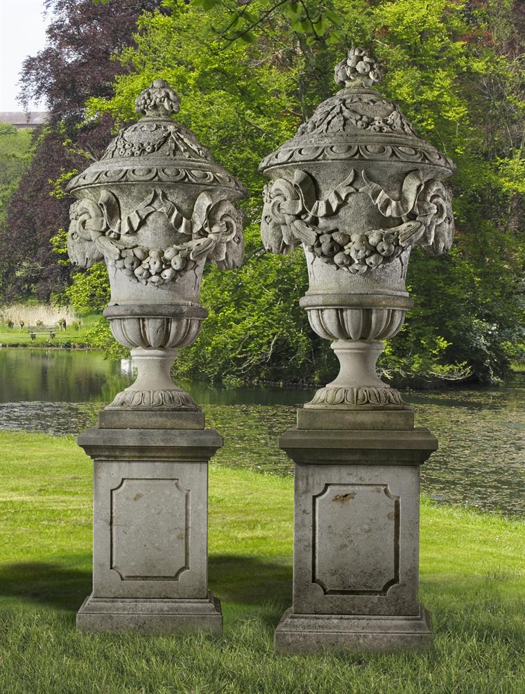 A pair of monumental Italian sculpted limestone urns in Neoclassical taste