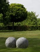 A pair of large limestone ornamental spheres