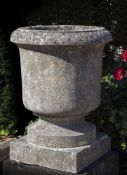 A carved limestone garden urn