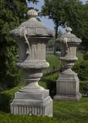 A pair of monumental carved limestone urns-and-covers