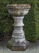 A carved limestone font