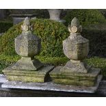 A pair of French carved sandstone pier finials