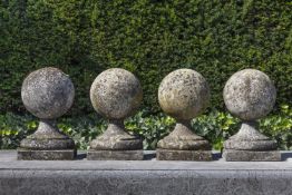 A set of four carved limestone pier finials