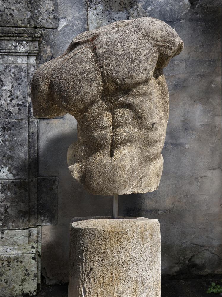 A sculpted limestone model of a male torso, after the manner of the Gaddi Torso