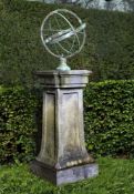 A bronze mounted carved bluestone armillary sphere